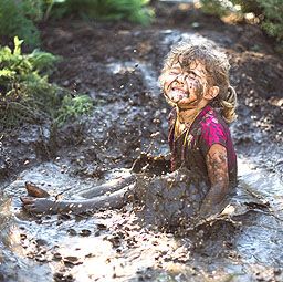 Girl (3-5) playing in mud